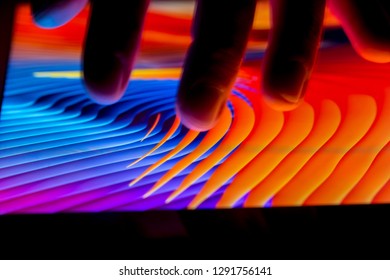 LONDON - JANUARY 15, 2019: Hand Using IPad Touch Screen Tablet Computer At Night