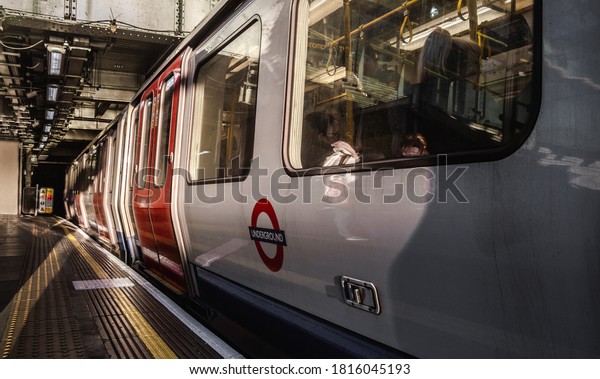 LONDON - JANUARY 16, 2019: Underground\
sub-surface train at a Tube station. Transport for London, England,\
United Kingdom.
