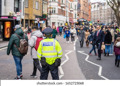 London, January 26, 2020. British Police Officer Patrolling The Streets Of England Wearing Stab Vest.