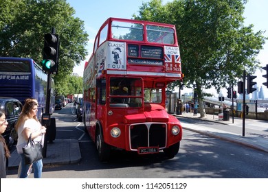 LONDON - JULY 17: Open top Routemaster Bus operating a tourist service in London on July 17, 2018 in London, UK. The open platform facilitated speedy boarding under the supervision of a conductor.