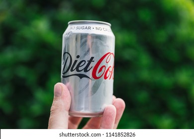 LONDON - July 18, 2018: Can of Diet Coke held on green garden background