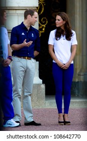 LONDON - JULY 26:  Kate Middleton, Prince William And Prince Harry Are Seen Outside Buckingham Palace Waving To Crowds, July 26, 2012 In London, Uk