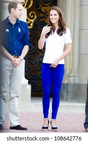 LONDON - JULY 26:  Kate Middleton, Prince William And Prince Harry Are Seen Outside Buckingham Palace Waving To Crowds, July 26, 2012 In London, Uk