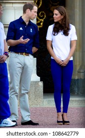 LONDON - JULY 26:  Kate Middleton, Prince William And Prince Harry Are Seen Outside Buckingham Palace Waving To Crowds, July 26, 2012 In London, Uk