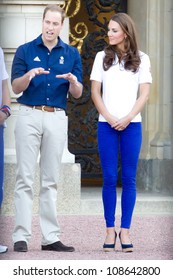 LONDON - JULY 26:  Kate Middleton, Prince William And Prince Harry Are Seen Outside Buckingham Palace Waving To Crowds, July 26, 2012 In London, Uk