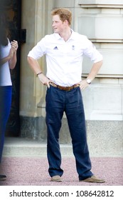 LONDON - JULY 26:  Kate Middleton, Prince William And Prince Harry Are Seen Outside Buckingham Palace Waving To Crowds, July 26, 2012 In London, Uk