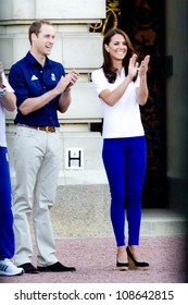 LONDON - JULY 26:  Kate Middleton, Prince William And Prince Harry Are Seen Outside Buckingham Palace Waving To Crowds, July 26, 2012 In London, Uk