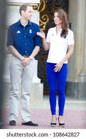 LONDON - JULY 26:  Kate Middleton, Prince William And Prince Harry Are Seen Outside Buckingham Palace Waving To Crowds, July 26, 2012 In London, Uk