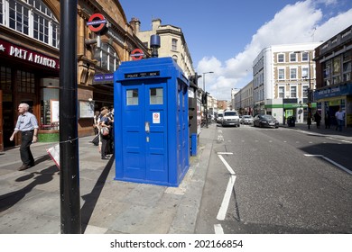 LONDON - JUNE 11, 2014: Public call police box with mounted a modern surveillance camera near Earl's Court tube station in London.