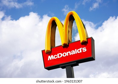 LONDON - JUNE 22: McDonalds logo on blue sky background on June 22, 2012, London, UK. It is the world's largest fast food chain, over 31,000 restaurants worldwide, serve 58 million customers each day
