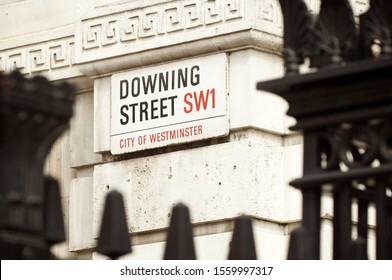 LONDON - JUNE 23, 2011: A road sign for Downing Street, where the residence of the Prime Minister is located, hangs on the wall of a building in the Whitehall political center.