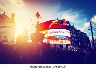 LONDON - JUNE 25: Vintage style artistic photograph of Piccadilly Circus neons at sunset, young night. This place is of the major tourist attractions on June 25, 2015 in London, UK.