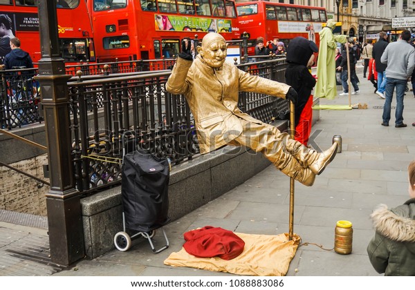 London, London\'s West End in the City of\
Westminster, UK, February 21, 2015. Piccadilly circus.Floating\
man,street artist.