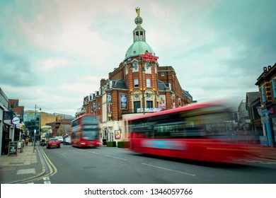 LONDON- MARCH, 2019: The New Wimbledon Theatre In South West London With Motion Blurred Traffic