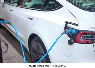 London, March, 2021, UK - A Close Up Shot Of A London Street With A Electric Car Plug Attached To A Electric Vehicle. You Can See The Street Environment In The Image Also. Nice Detail On The Plug.