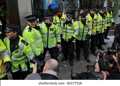 LONDON - MARCH 26: Press Photograph Police As They Form A Line To Protect A High Street Shop That Came Under Attack By Protesters During A Large Anti-cuts Rally On March 26, 2011 In London, UK.