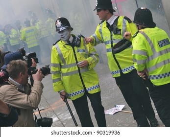 LONDON - MARCH 26: Press Photograph Police After Coming Under Attack By A Breakaway Group Of Protesters During A Large Anti-cuts Rally On March 26, 2011 In London, UK.