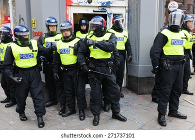 LONDON - MARCH 26: Riot Police Stand Guard Outside A Branch Of HSBC After The Bank Comes Under Attack By A Breakaway Group Of Protesters During A Large Anti Cuts Rally On March 26, 2011 In London, UK.