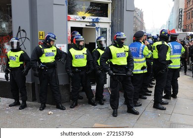 LONDON - MARCH 26: Riot Police Stand Guard Outside A Branch Of HSBC After The Bank Comes Under Attack By A Breakaway Group Of Protesters During A Large Anti Cuts Rally On March 26, 2011 In London, UK.