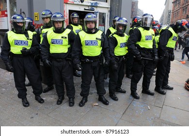 LONDON - MARCH 26: Riot Police Stand Guard Outside A Branch Of HSBC After The Bank Comes Under Attack By A Breakaway Group Of Protesters During A Large Anti-cuts Rally On March 26, 2011 In London, UK.