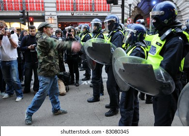 LONDON - MARCH 26: An Unidentified Protester Confronts Riot Police During A Large Anti-cuts Rally March 26, 2011 In London, UK.