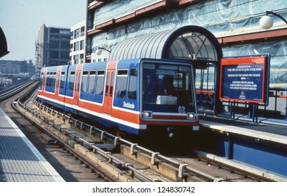 LONDON - MARCH 30: An Automatic Electric Multiple Unit Train Arrives At South Quay Station On The Docklands Light Railway On March 30, 1990 In London. Some 25 Miles Long, The DLR Opened In July 1987.