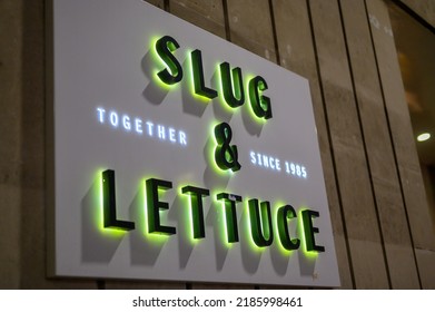 LONDON - May 17, 2022: Illuminated Sign For Slug And Lettuce Pub At Night