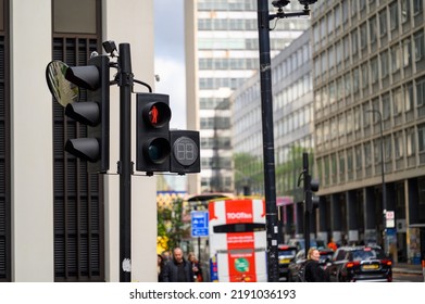 LONDON - May 20, 2022: Pedestrian Crossing Traffic Lights Above A Busy London Street