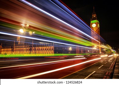 London Night Scene Of Westminster And Big Ben With Famous London Bus Driving By