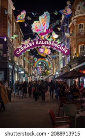 LONDON - NOVEMBER 1, 2021: Colourful Christmas Decorations Suspended Above A Busy Carnaby Street