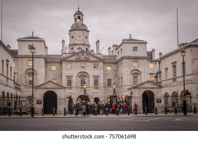 LONDON- NOVEMBER, 2017: People gather at the Horse Guard Barracks to watch the 'changing of the guard' a popular tourist attraction in Whitehall, London. 