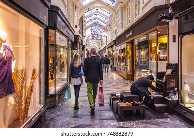 LONDON- NOVEMBER, 2017: Shoppers and shoe shiner in the interior of Burlington Arcade, a high end Victorian shopping gallery located next to Bond Street, London. 