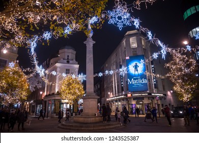 LONDON - NOVEMBER 26, 2018: Christmas Lights Twinkle Around The Stone Monument At Seven Dials, The West End Neighborhood Bordering The Theatre District And Covent Garden.