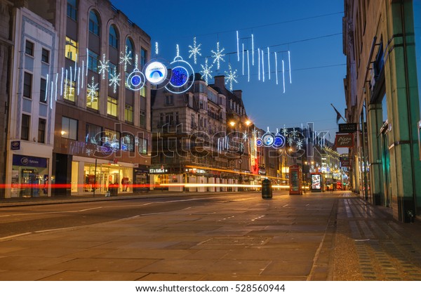 LONDON - NOVEMBER 27, 2016: Strand\
street with Christmas decorations and car light trails \
