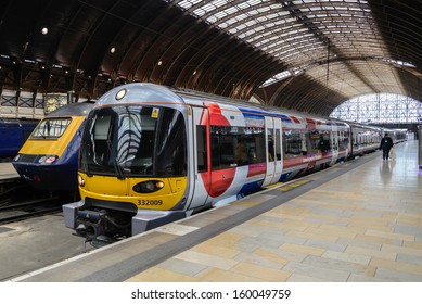 LONDON - OCT 8: A train pulls into Paddington station on Oct 8, 2012 in London, UK. Paddington station is one of the busiest in Europe with more than 100 trains per hour during peak times.
