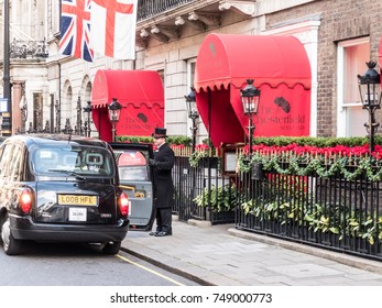 London, October 2017. A Doorman And Black Taxi Outside The Chesterfield Hotel In Mayfair.