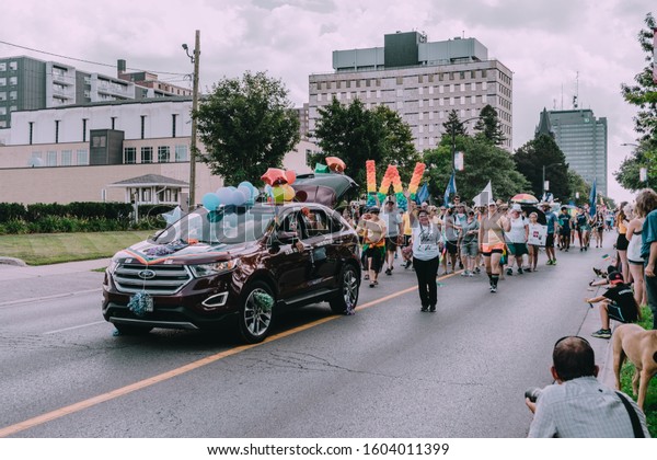 London, Ontario /\
Canada 07.28.19 Pride Parade in London Ontario with Star Wars Storm\
Trooper and Darth Vader, colourful balloons, umbrellas, flags,\
floats, dancers and a\
band