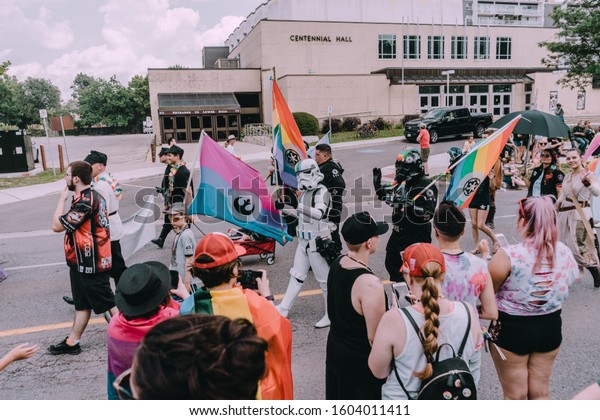 London, Ontario /\
Canada 07.28.19 Pride Parade in London Ontario with Star Wars Storm\
Trooper and Darth Vader, colourful balloons, umbrellas, flags,\
floats, dancers and a\
band