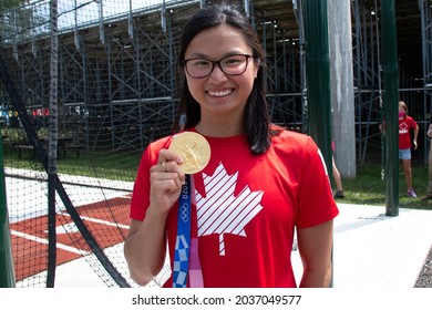 London, Ontario, Canada - August 28 2021: Canadian Olympic Swimming Champion Maggie MacNeil Holds Up Her Gold Medal From Tokyo 2020 Where She Won The Women's 100 Metre Butterfly Race.