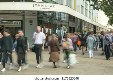 LONDON- SEPTEMBER, 2018: Exterior of John Lewis flagship department store on Oxford Street with motion blurred shoppers walking past