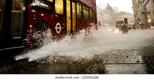 LONDON, SEPTEMBER, 2019: A Wet London Street Scene With A Bus Splashing Rain Water On To The Pavement In Regent Street