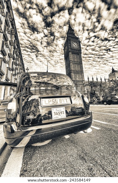 LONDON - SEPTEMBER 27, 2013: Taxi cab awaits\
customer in front of Big Ben. There are almost 25,000 licensed taxi\
cabs in London.