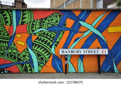 LONDON - SEPTEMBER 27. Painted Mural On A Building Site Hoarding By The Road Sign On September 27, 2014 In Hanbury Street In The E1 Area Of London, UK.