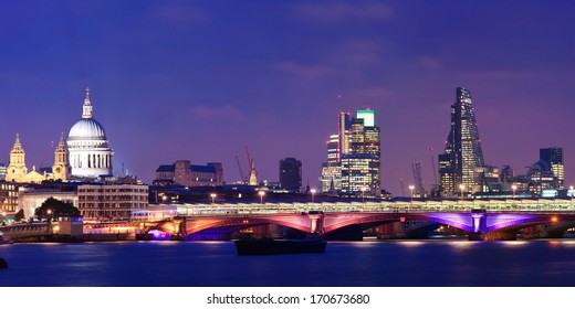 London Skyline At Night With Bridge And St Pauls Cathedral Over Thames River.