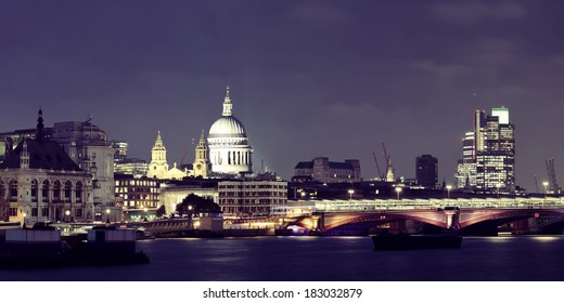 London Skyline At Night With Bridge And St Pauls Cathedral Over Thames River.