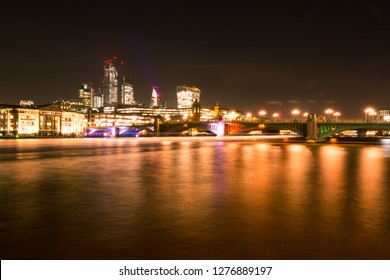 London Skyline at Night with Thames River, Bridges, City Buildings and Riverboats Crossing - Powered by Shutterstock