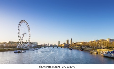 London Skyline View At Sunrise With Famous Landmarks, Big Ben, Houses Of Parliament And Ships On River Thames With Clear Blue Sky - England, UK