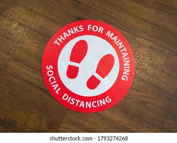 London, Stratford UK, August 9th 2020: A Restaurant Floor Sign For Maintaining Social Distance. Safe Distancing Measures In Public Places. Floor Sticker Sign During Covid-19, Coronavirus.Typo Space.