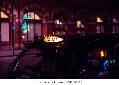 London Taxi Waiting At Night With Light On