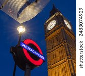 London Tourism, Big Ben and London Underground sign for Westminster Station. Looking up at the sky with iconic London landmarks. European capital city tourism and background. 